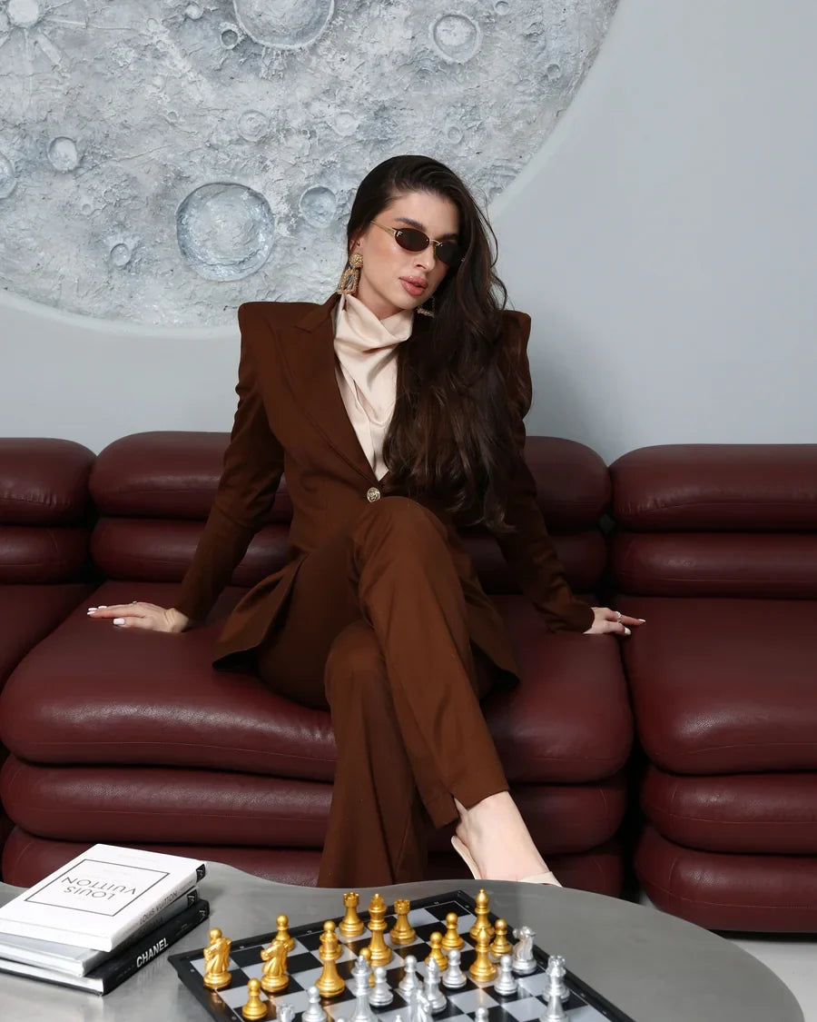 The DIID Imperia Set in chocolate brown, styled seated at a chess table for the evening