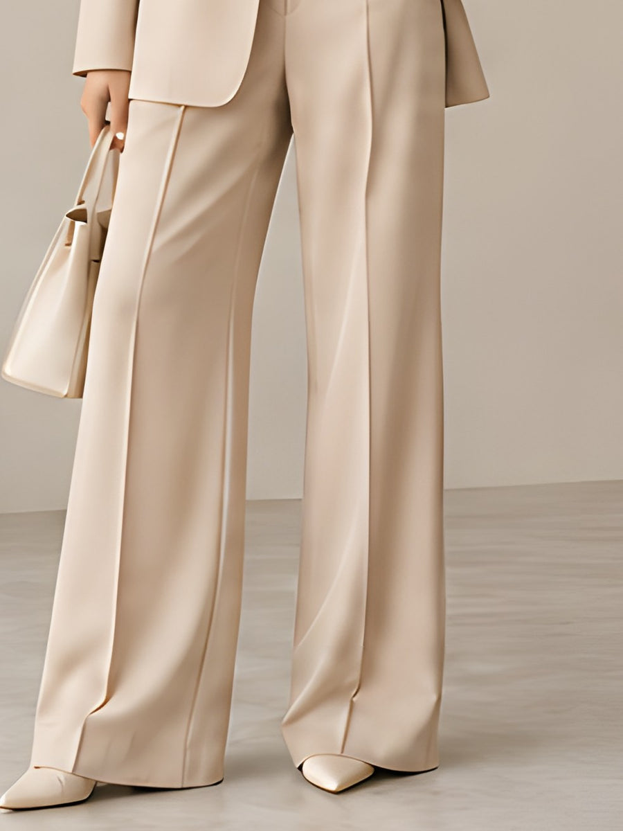 DIID Fluid Tailored Trousers in beige with a wide leg and pressed crease