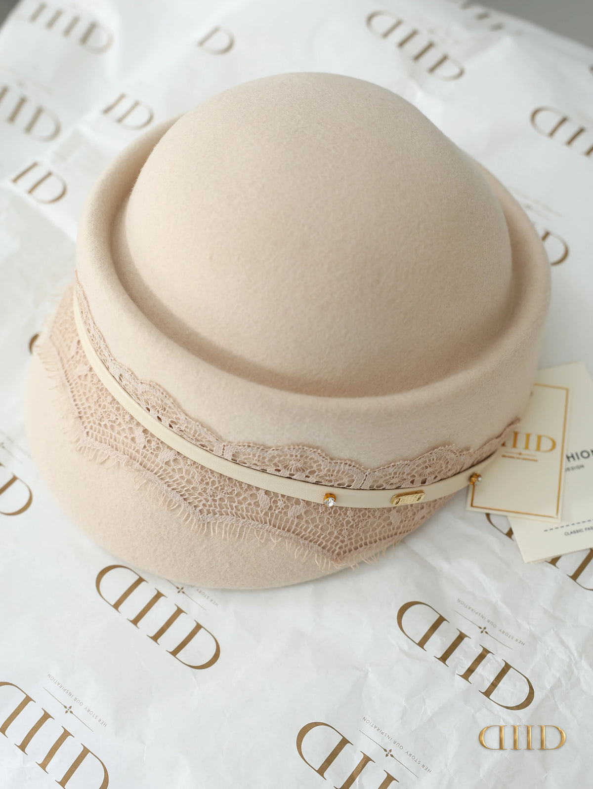 Ivory felt cloche hat with the lace band, seen from above