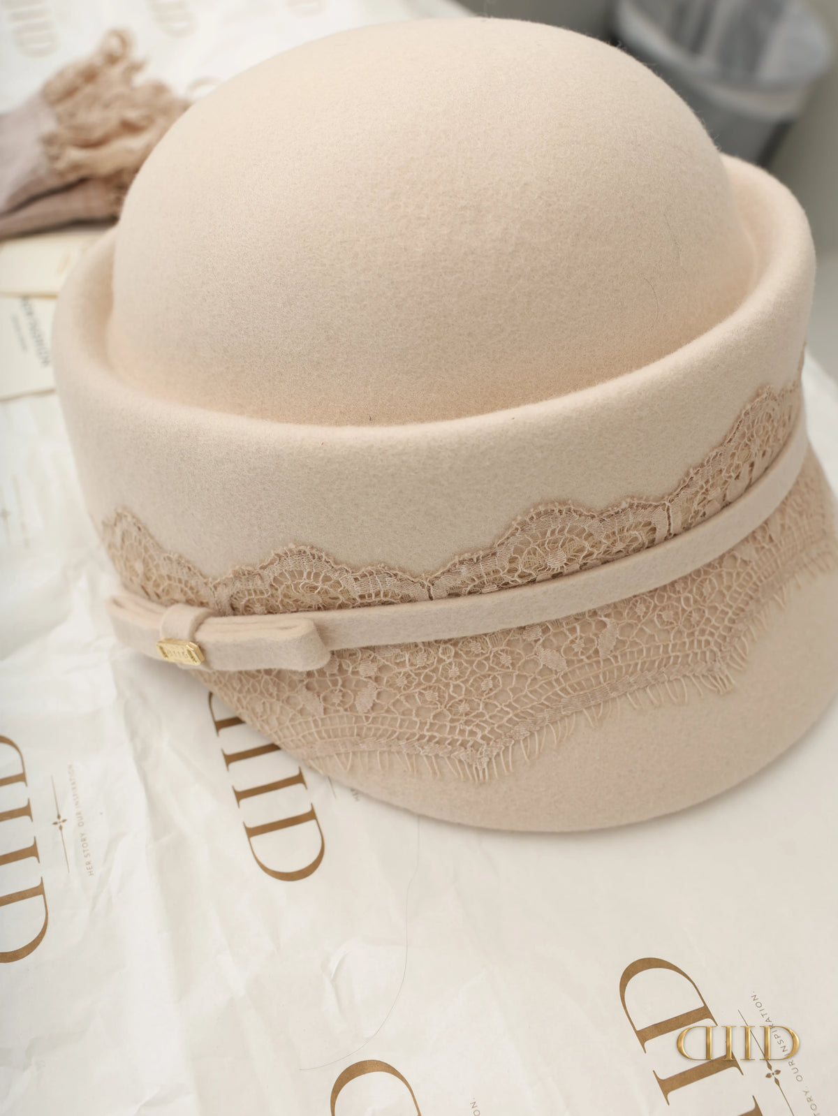 Front view of the ivory cloche hat and lace band