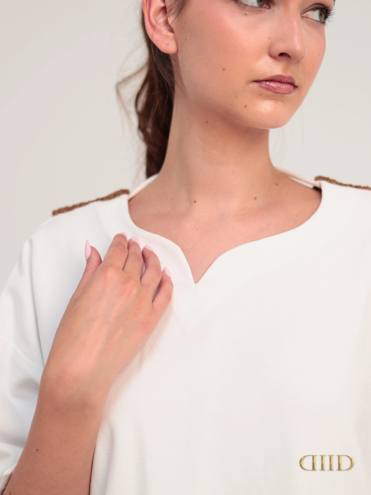 Close-up of the neckline of the white cotton-spandex top