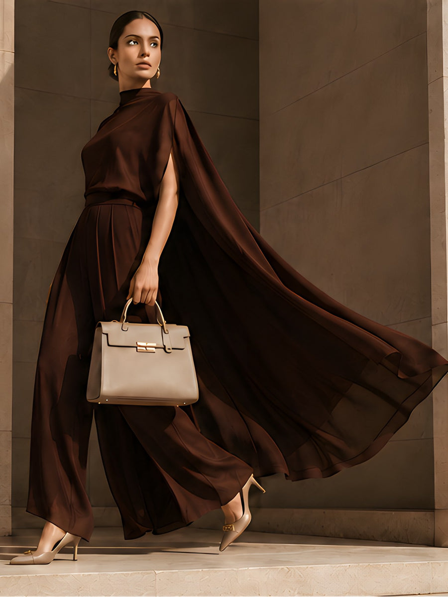 Chocolate satin column look by DIID with a flowing drape, worn with a structured handbag