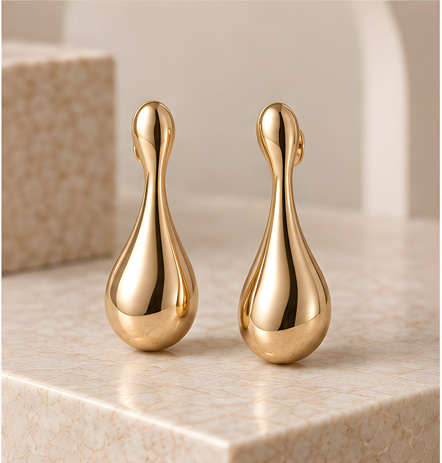 Pair of DIID Sculpted Drop Earrings in a champagne-gold tone with a high-polish finish
