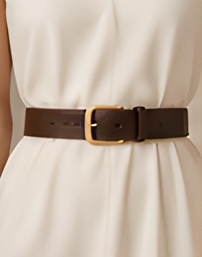 DIID chocolate leather belt worn at the waist over an ivory dress